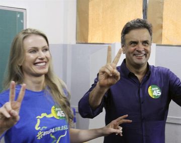 El candidato opositor Neves votó y saludó con el gesto de la victoria