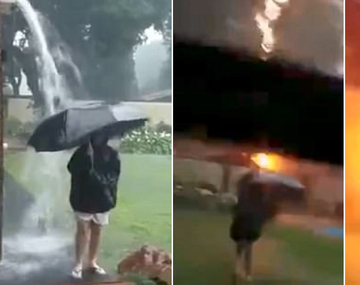 VIDEO: Jugaba con el paraguas bajo la lluvia