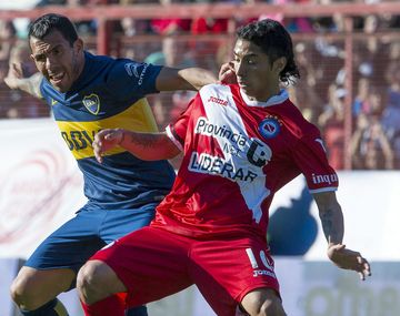 Luciano Cabral disputando una pelota con Carlos Tevez