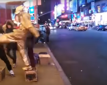 Le quiso sacar plata a una estatua viviente