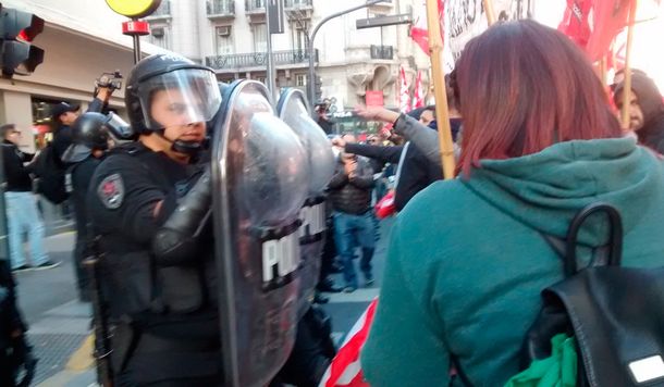 Los trabajadores se enfrentan a la policía que no quiere que corten la calle.